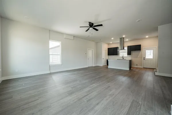 a view of kitchen with stove and wooden floor