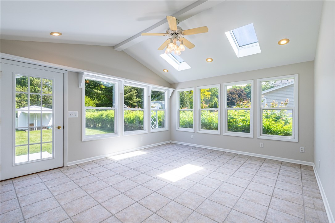 274 Parkview Drive Rochester, NY 14625 - Photo 13 of 41 Second sunroom with walls of windows. Door to wraparound deck