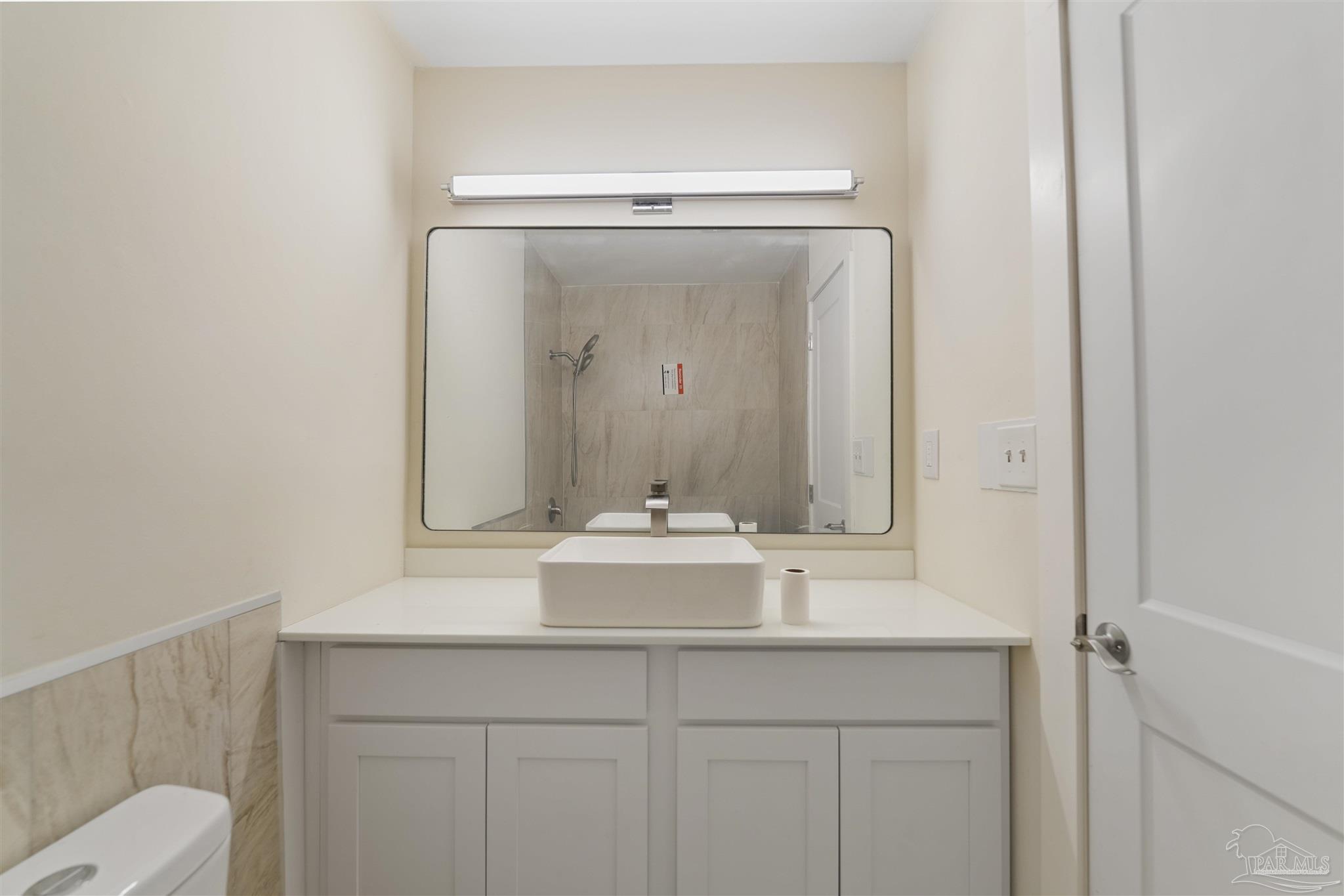 842 Belair Road Pensacola, FL 32505 - Photo 16 of 20 a bathroom with a sink and a mirror with toilet