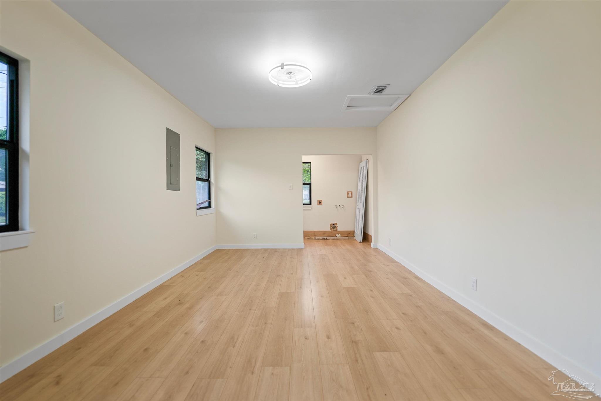 842 Belair Road Pensacola, FL 32505 - Photo 18 of 20 an empty room with wooden floor and windows