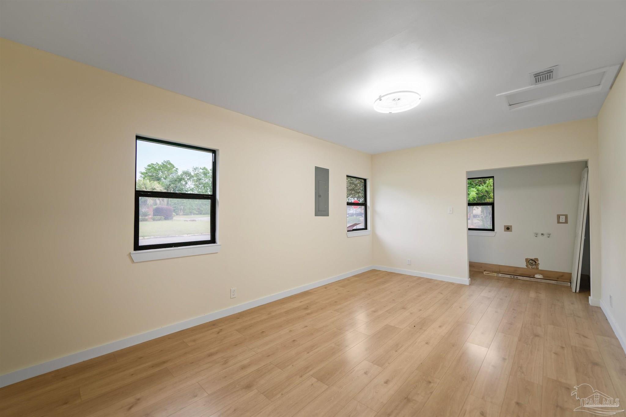 842 Belair Road Pensacola, FL 32505 - Photo 19 of 20 an empty room with wooden floor and windows