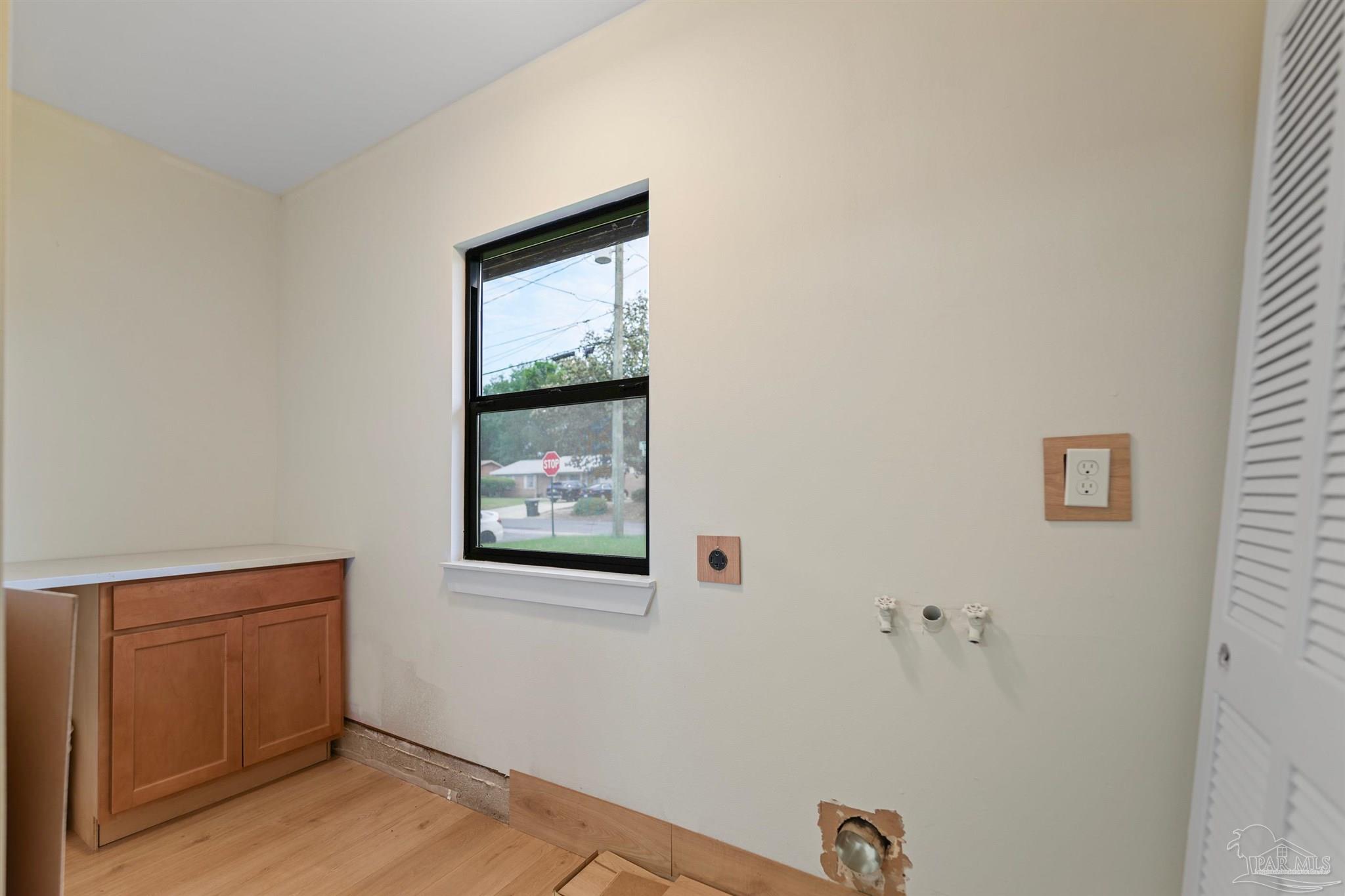 842 Belair Road Pensacola, FL 32505 - Photo 20 of 20 a view of an empty room with wooden floor and a window