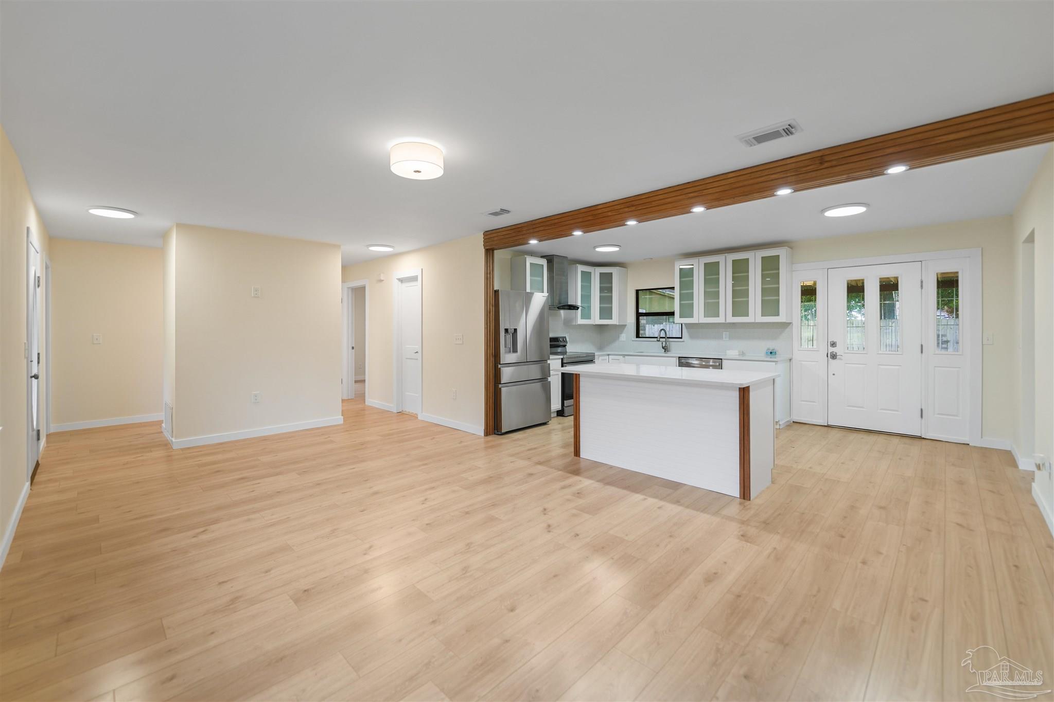 842 Belair Road Pensacola, FL 32505 - Photo 5 of 20 a large white kitchen with stainless steel appliances granite countertop a large counter top and a stove top oven