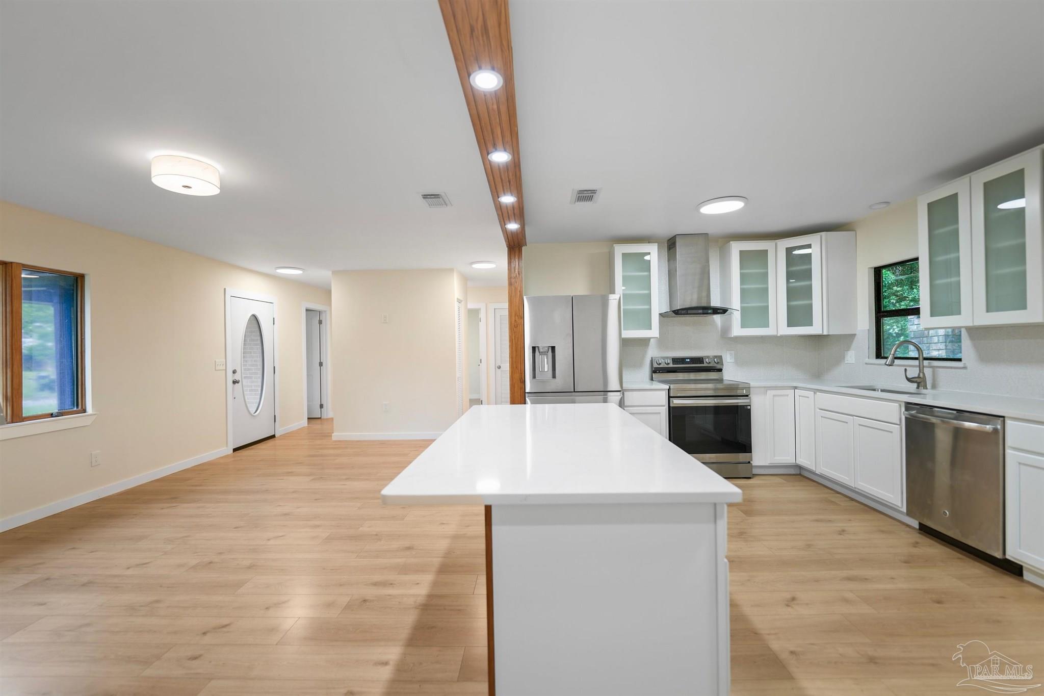 842 Belair Road Pensacola, FL 32505 - Photo 6 of 20 a large kitchen with kitchen island a sink stainless steel appliances and cabinets