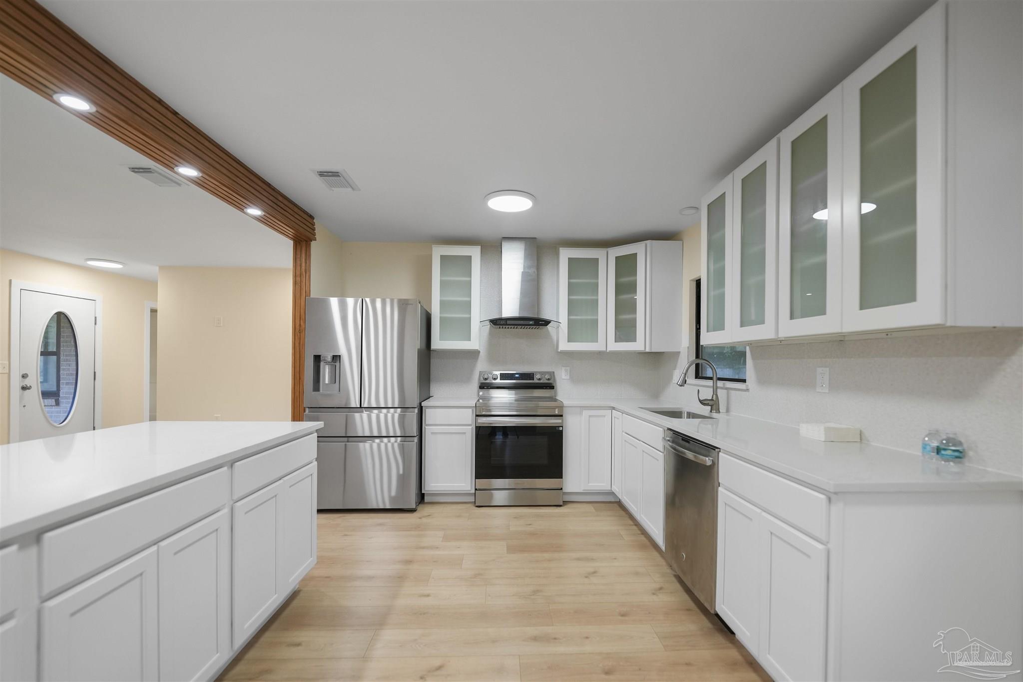 842 Belair Road Pensacola, FL 32505 - Photo 7 of 20 a kitchen with a sink stainless steel appliances and cabinets