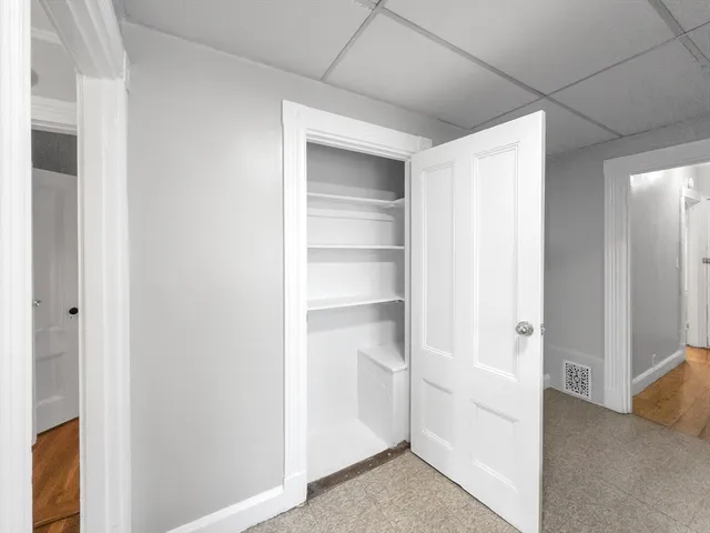 a view of walk in closet with empty racks