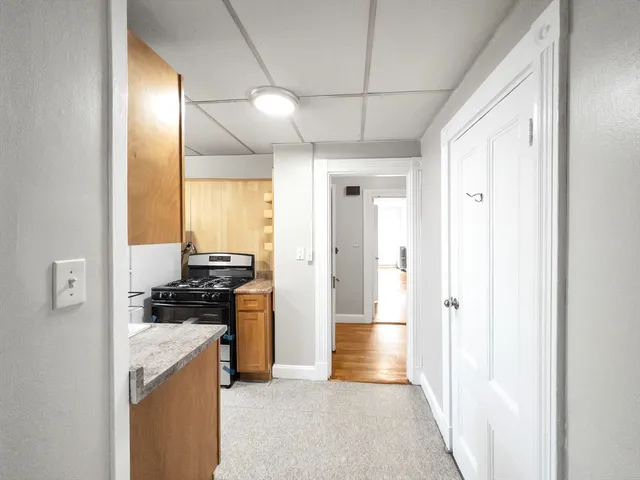 a kitchen with stainless steel appliances granite countertop a refrigerator and a stove