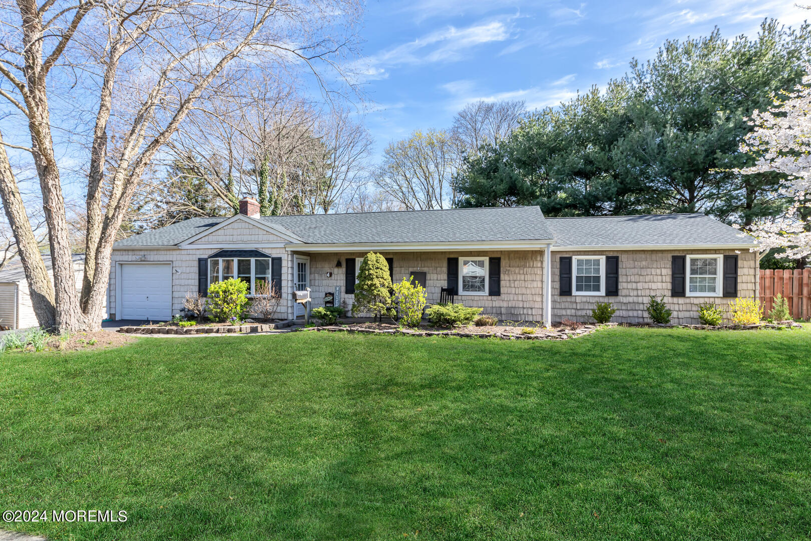 a front view of a house with swimming pool having outdoor seating