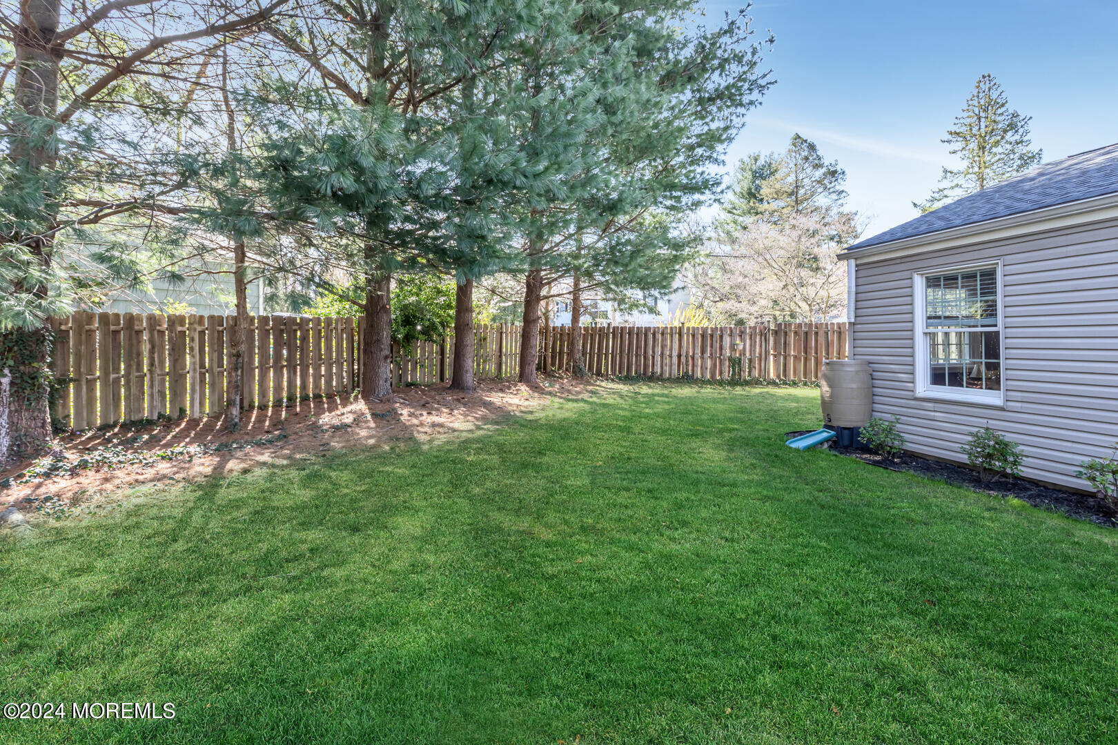 4 Cherry Tree Lane Middletown, NJ 07748 - Photo 29 of 31 a view of a yard with a large tree and wooden fence