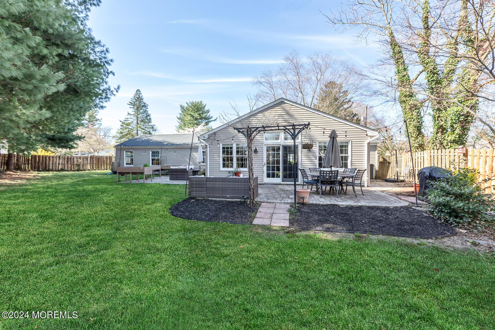4 Cherry Tree Lane Middletown, NJ 07748 - Photo 31 of 31 a front view of a house with a yard table and chairs