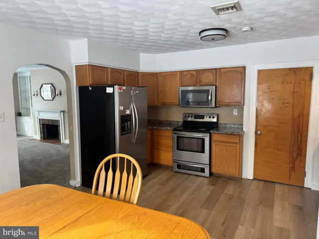 a kitchen with stainless steel appliances a refrigerator and a stove top oven