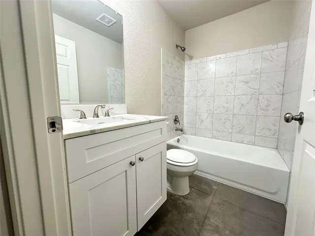 a bathroom with a sink a toilet and bathtub