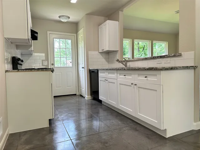 a kitchen with a sink cabinets and window
