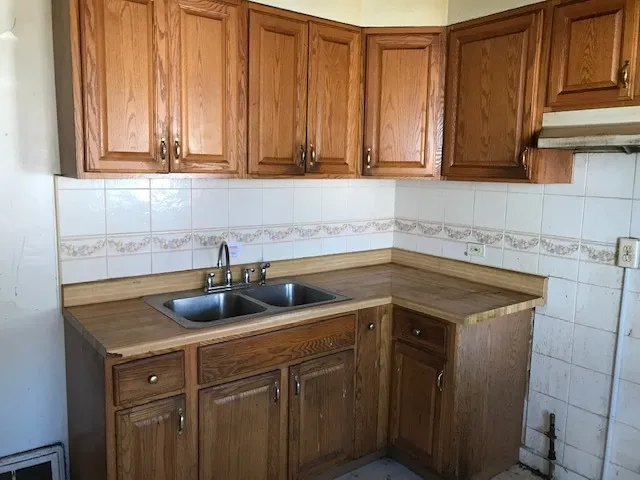 a kitchen with a sink cabinets and a window
