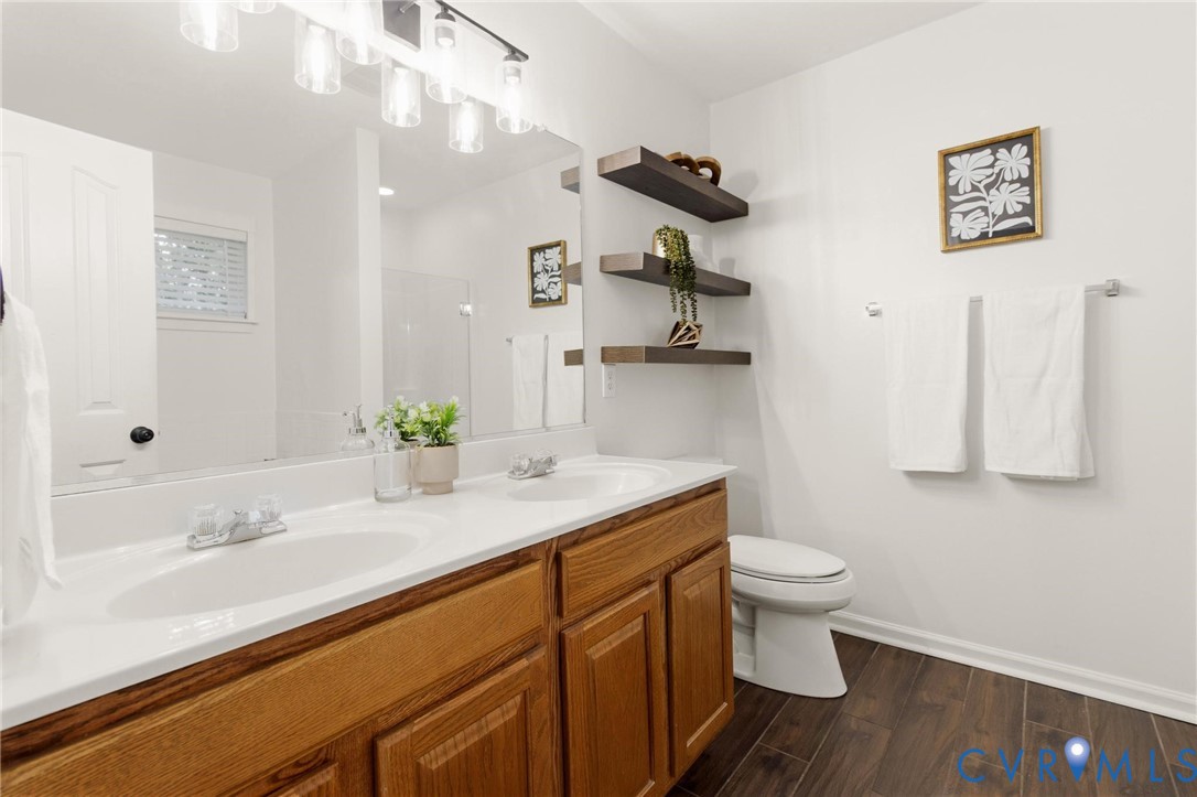 7807 Clover Ridge Place Chesterfield, VA 23832 - Photo 31 of 51 Bathroom featuring a dual-sink vanity with wood-fi