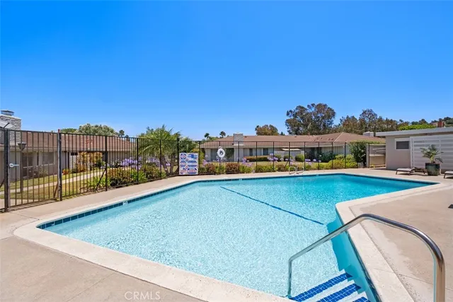 a view of a swimming pool with a lounge chair and city view