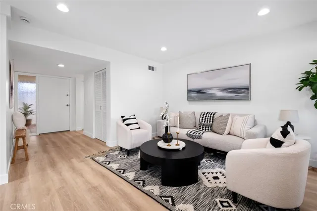 a living room with furniture and view of kitchen