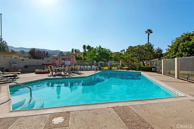 swimming pool view with a seating space