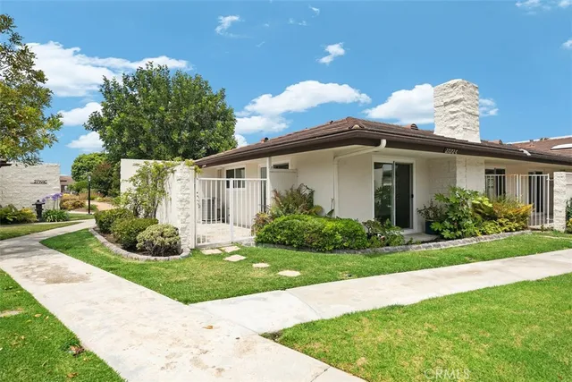 a view of a house with yard and a garden