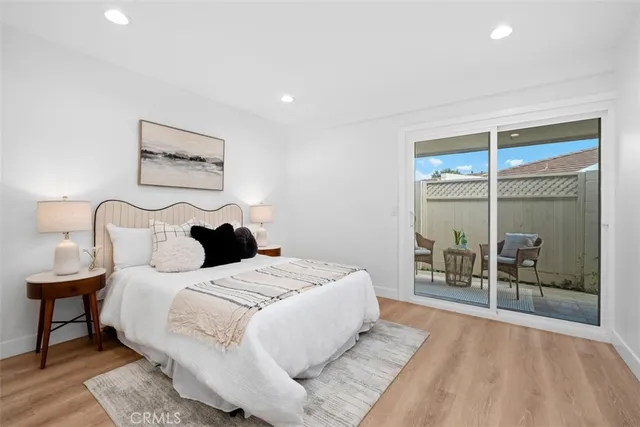 a large bedroom with a bed and glass door