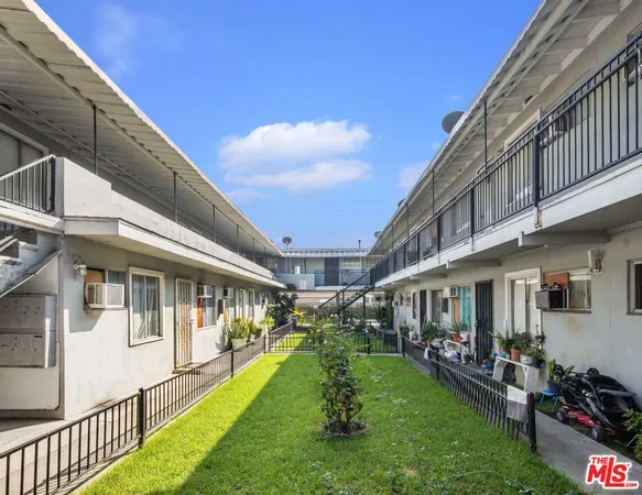 a view of a house with many windows and a yard