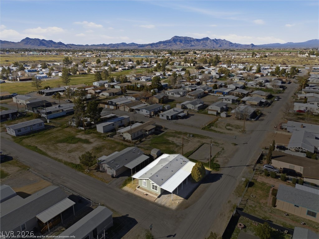 20 Rudy Road Pahrump, NV 89048 - Photo 28 of 32 An aerial perspective showcases a corner lot home situated against a scenic mountain backdrop.