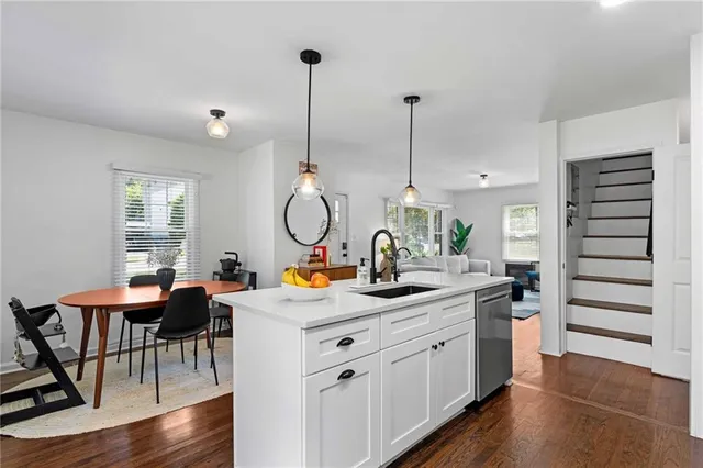 a view of a kitchen area with furniture and wooden floor