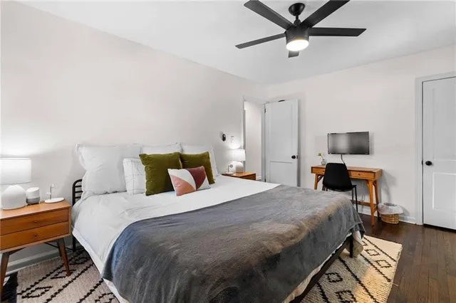 a bedroom with a bed and wooden floor