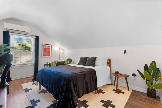 a bedroom with a bed and a potted plant