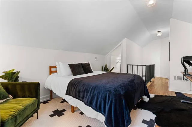 a bedroom with a bed and a couch