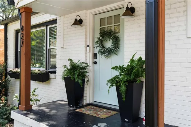 a view of a entryway of the house with potted plants