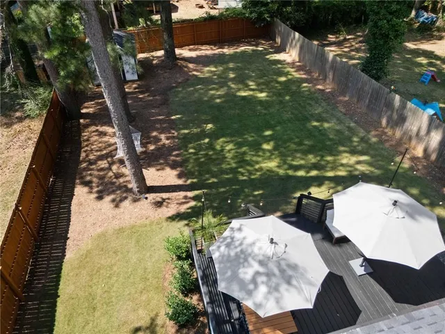a terrace of a house with wooden floor outdoor seating and kitchen view