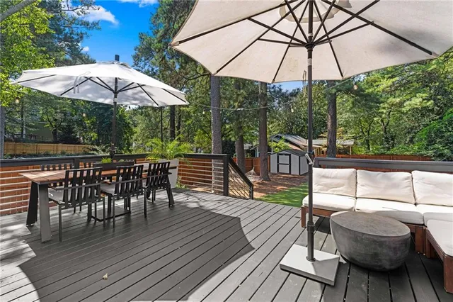 a view of backyard with seating space and trees