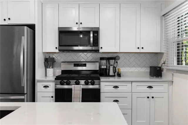 a kitchen with appliances a cabinets and a counter space