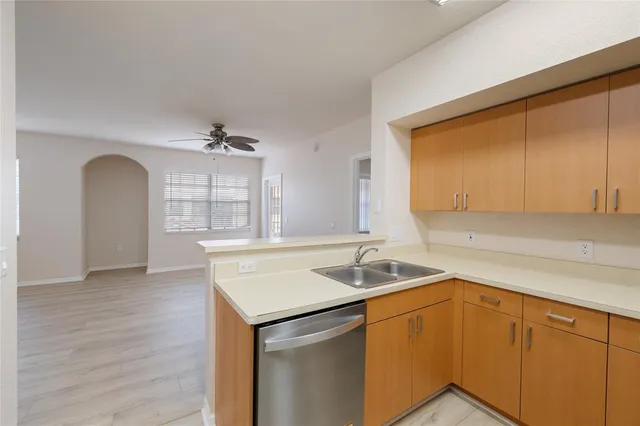 a kitchen with a sink cabinets and window