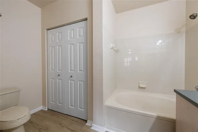 a bathroom with a toilet and bathtub