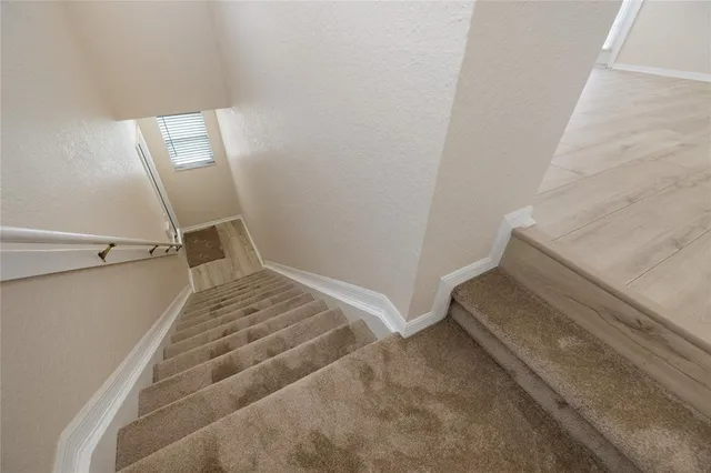 a view of staircase with white walls
