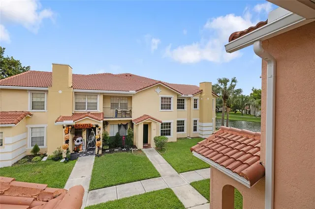 a front view of a house with a garden and plants