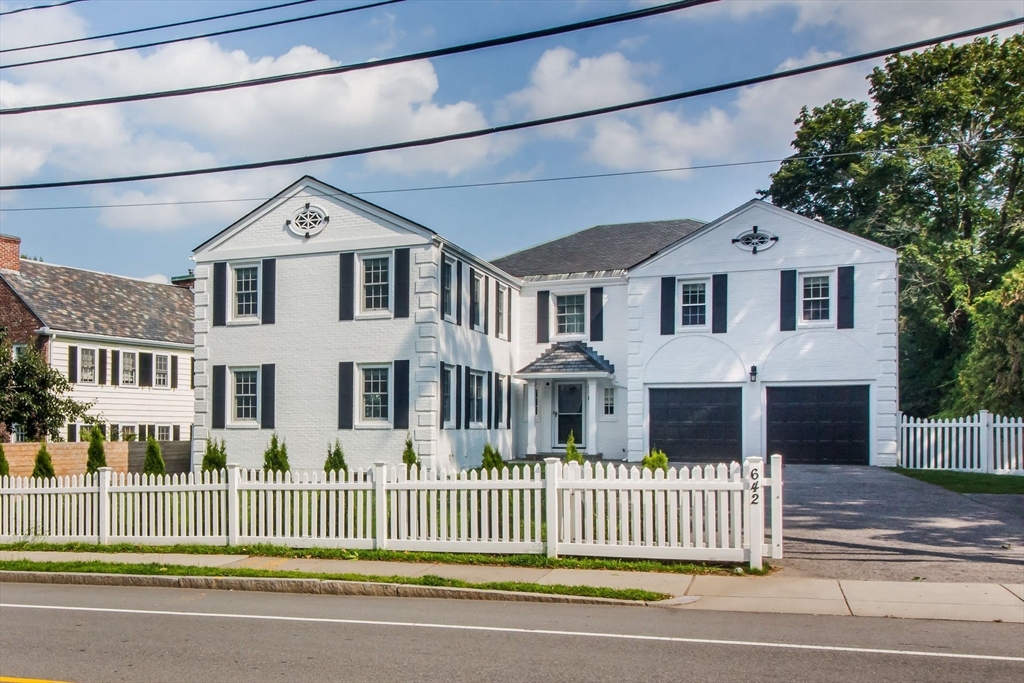 a front view of a house with a fence