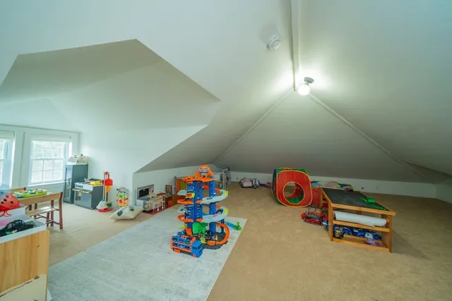 a bedroom with a bed and a wall painting