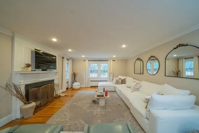 a living room with furniture a fireplace and a flat screen tv