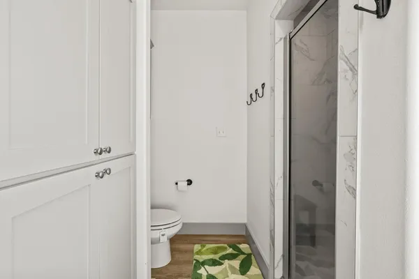 a bathroom with a toilet and a shower