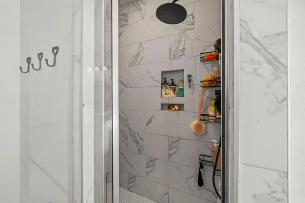 a bathroom with a shower and mirror