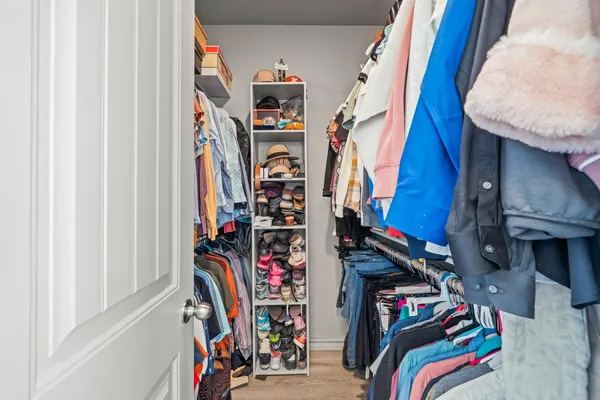 a view of walk in closet with clothes