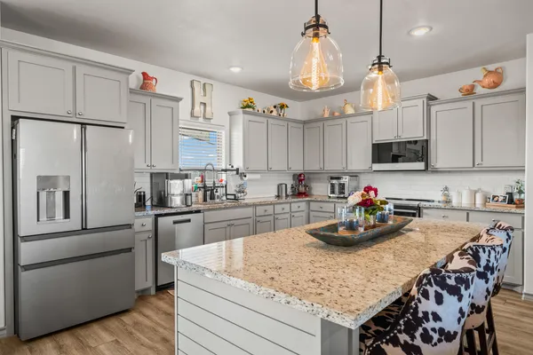 a kitchen with refrigerator a stove and cabinets