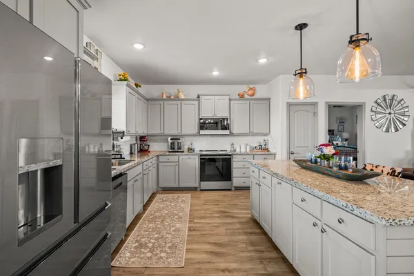 a kitchen with a sink stainless steel appliances and cabinets