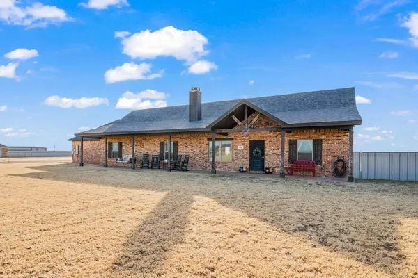 a view of a house with a yard and sitting area