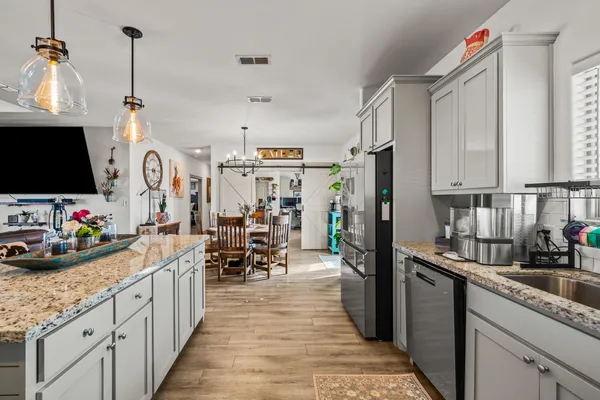 a kitchen with refrigerator and cabinets