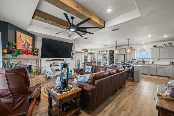 a living room with fireplace furniture and a flat screen tv