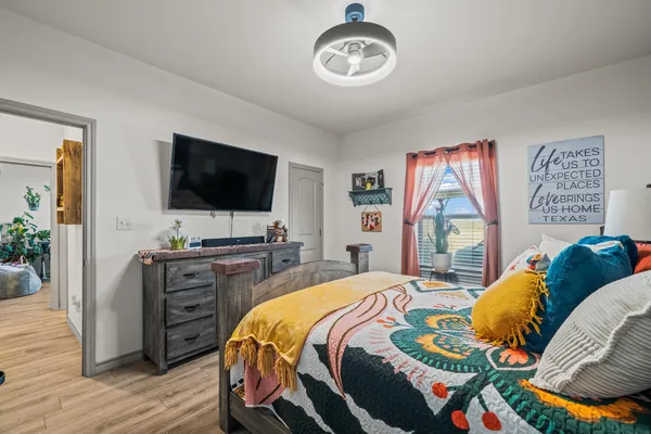 a bedroom with a bed and a flat screen television